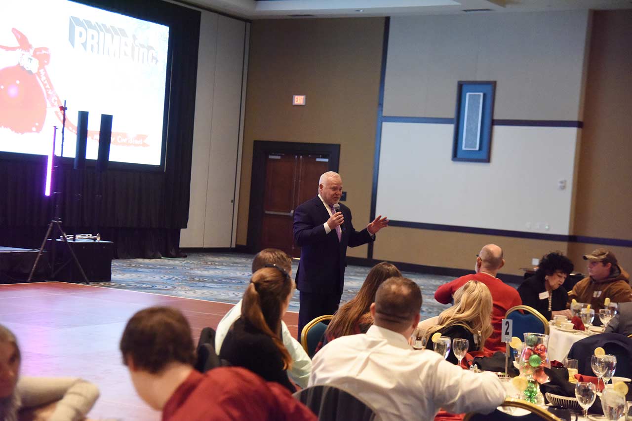Robert Low gives a speech at the Prime Annual Christmas Party.